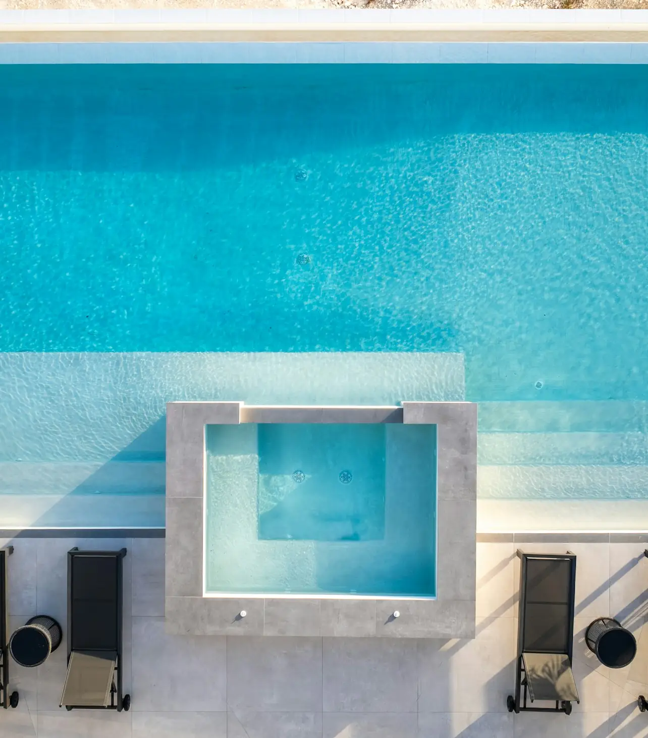 Piscina con césped y tumbonas